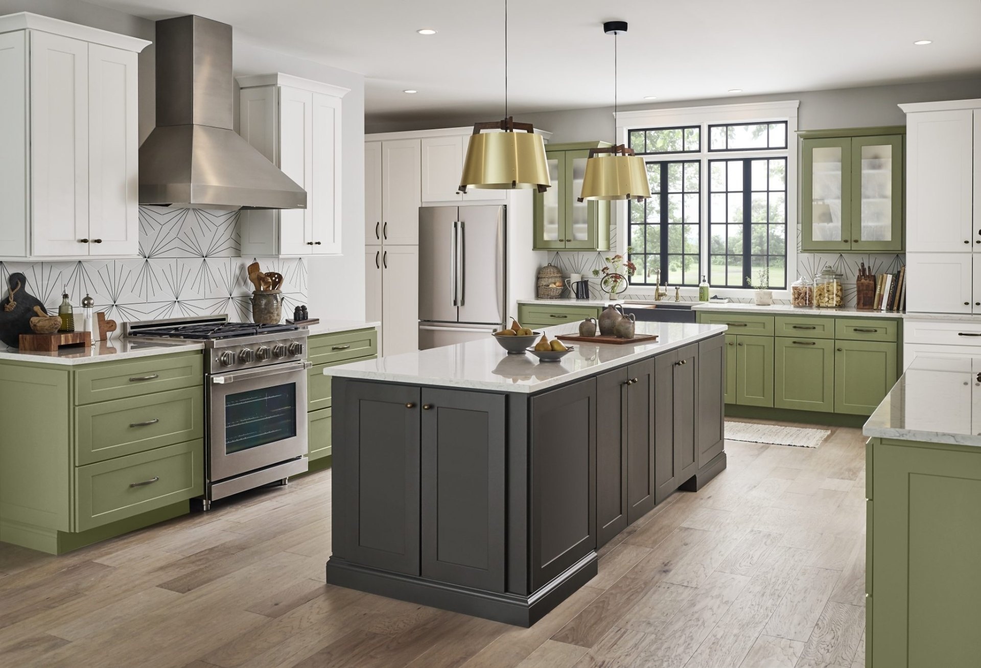 Wolf Classic Dartmouth 5-Piece kitchen with painted sage and white cabinets, brushed brass pendant lights, and a dark island